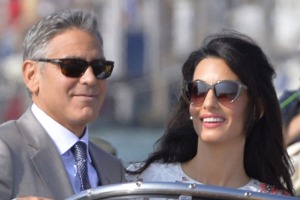 US actor George Clooney and his wife Amal Alamuddin stand on a taxi boat in Venice.