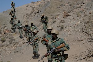 File - Djiboutian army soldiers head out on patrol during Operation Able Dart 08-01 on Forward Operating Location Ali Sabieh, Djibouti, March 4, 2008.