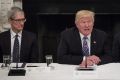 Donald Trump speaks as Apple CEO Tim Cook and Microsoft CEO Satya Nadella listen.