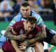 Solid defence: Michael Morgan of the Maroons drops the ball in a tackle by Mitchell Pearce and Josh Dugan.