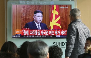 South Koreans watch a TV news program showing North Korean leader Kim Jong Un's New Year's speech, at the Seoul Railway Station in Seoul, South Korea, Sunday, Jan. 1, 2017.