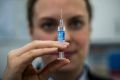 Chemist Elise Apolloni administers an injection at the Wanniassa Capital Chemist.