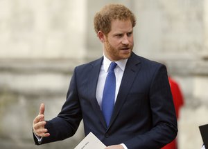 Britain's Prince Harry leaves after attending a service of commemoration for the victims of the 2015 terrorist attacks in Tunisia at Westminster Abbey in London, Tuesday, April 12, 2016