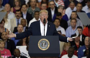 President Donald Trump gestures during a campaign rally Saturday, Feb. 18, 2017, in Melbourne, Fla.