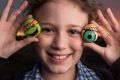 Keira Sen, 9, with some of the rocks she has painted ready to be 'dropped' at a local park.