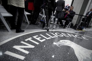 In this Jan. 21, 2017, file photo, President Donald Trump, background, speaks at the Central Intelligence Agency in Langley, Va.