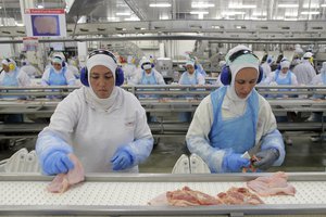 Workers prep poultry at the meatpacking company JBS, in Lapa, in the Brazilian state of Parana, Tuesday, March 21, 2017.