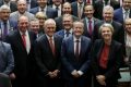 Prime Minister Malcolm Turnbull and Opposition Leader Bill Shorten pose with parliamentarians. One in three voters ...