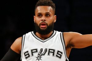 San Antonio Spurs guard Patty Mills (8) gestures after making a three point basket during the second half of an NBA ...