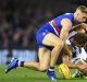 Talking point: Shaun Higgins of the Kangaroos is tackled by Jake Stringer of the Bulldogs.