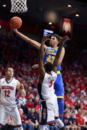 Jonah Bolden of the UCLA Bruins shoots over Kadeem Allen of the Arizona Wildcats during a college basketball game in ...