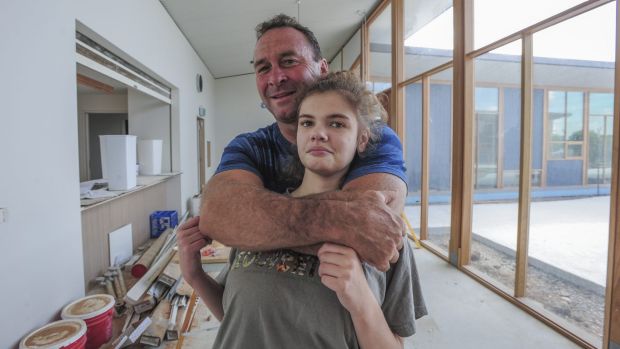 Canberra Raiders coach Ricky Stuart, pictured with his 18-year-old autistic daughter Emma at his respite house, wants ...