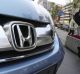 A man walks past a Honda on display at Honda headquarters in Tokyo. Honda recalled an additional 4.89 million vehicles ...