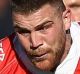 SYDNEY, AUSTRALIA - JUNE 25: Josh Dugan of the Dragons is tackled during the round 16 NRL match between the St George ...