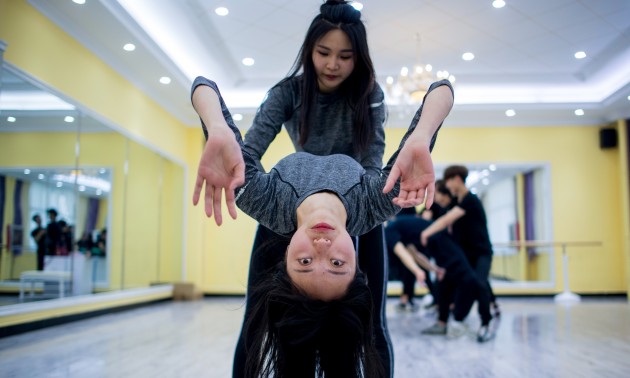 Wang Xin (top) attending a dance class at the Yiwu Industrial & Commercial College in Yiwu, east China's Zhejiang Province. 
Hordes of Chinese millennials are speaking directly to the country's 700 million smartphone users. Photo: AFP/ Johannes Eisele