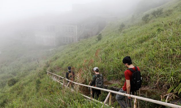 Road to the past: HK Urbex members walk toward an abandoned British army barracks. Photo: Reuters/Tyrone Siu