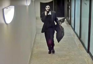 This undated security camera photo released by the FBI shows a serial bank robber, who authorities called the "Dreaded Bandit" because of the wig he used to disguise himself, in the process of robbing a San Francisco Bay-area bank. The FBI said Monday, Aug. 15, 2016, the man FBI agents and San Francisco police officers arrested in San Francisco's Richmond District is suspected of robbing several banks in the Bay Area.