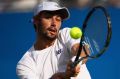 Jordan Thompson of Australia plays a backhand during the mens singles first round match against Andy Murray.