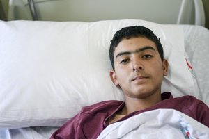 A Syrian man rests in a hospital in Reyhanli, Turkey, Friday, April 7, 2017.