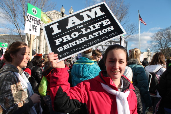 A young woman takes part in the 2015 March for Life in front of the Supreme Court of the United States. Photo via Flickr and courtesy of Elvert Barnes.