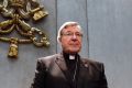 Cardinal George Pell arrives to make a statement at the Vatican on Thursday.