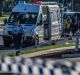 Police and emergency services at the scene of the Queanbeyan service station stabbing. 