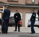 Detectives search a white work van outside the 24-year-old's house on Thursday morning. 