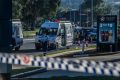 Police and emergency services at the scene of the Queanbeyan service station stabbing. 