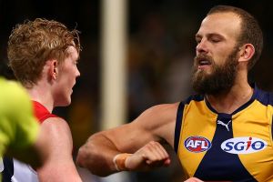 Will Schofield of the Eagles raises his forearm towards Clayton Oliver of the Demons at half time. 