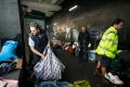 Nigel Blakemore, who had been living in Martin Place, cleans up belongings after the City of Sydney removed the homeless ...