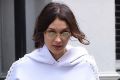 Bella Hadid doing her bit to make tiny glasses happen. 