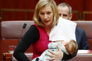 Senator Larissa Waters puts forward a motion in the Senate while breastfeeding her baby Alia.