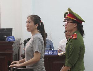 Prominent blogger Nguyen Ngoc Nhu Quynh stands trial in the south central province of Khanh Hoa, Vietnam on Thursday June 29, 2017. She was accused of distorting government policies and defaming the Communist regime on her Facebook posts, her lawyer said.Quynh, also known as