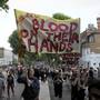 Demonstrators hold up banners during a march in Kensington, following the fire that destroyed The Grenfell Tower block, in north Kensington, West London, Britain June 16, 2017. REUTERS/Toby Melville