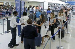 Travelers stand in line as they prepare go to through a Transportation Security Administration checkpoint at Fort Lauderdale-Hollywood International Airport, Friday, May 27, 2016, in Fort Lauderdale, Fla.