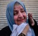 A woman weeps with relief as she waits to be taken to a displaced people's camp at a screening point in western Mosul.