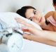 GENERIC. Please credit iStockphoto Young couple waking up in the morning , woman putting off an alarm clock woman; man; ...