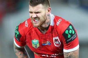 GOLD COAST, AUSTRALIA - JUNE 30: Josh Dugan of the Dragons leaves the field injured during the round 17 NRL match ...