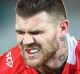 GOLD COAST, AUSTRALIA - JUNE 30: Josh Dugan of the Dragons leaves the field injured during the round 17 NRL match ...