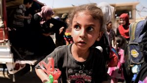 A girl in state of shock arrives with her family at a screening point in western Mosul after being rescued by Iraqi forces.