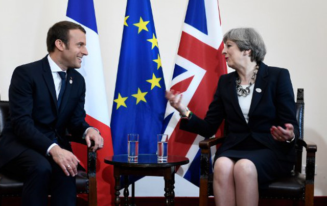 Buoyant Macron hosts weakened Theresa May in Paris for hard talks on Brexit