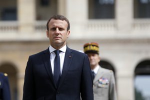 France's President Emmanuel Macron observes the French Flag, during a military ceremony