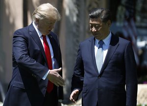 President Donald Trump and Chinese President Xi Jinping walk together at Mar-a-Lago, Friday, April 7, 2017, in Palm Beach, Fla.