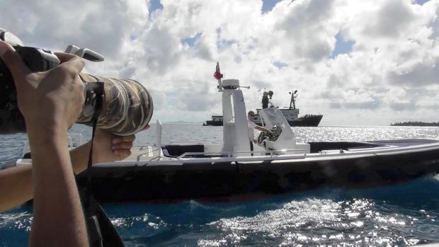 An Arctic P crew member parked a tender boat in front of the photographer's boat in an attempt to block their view.