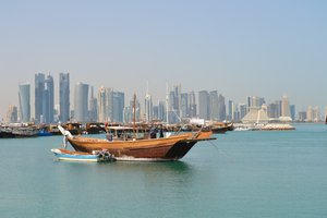 View on Doha skyline, Buildings, Towers, Boats on river - Qatar.