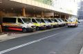 Ambulances wait at Liverpool Hospital after transporting patients on Tuesday.