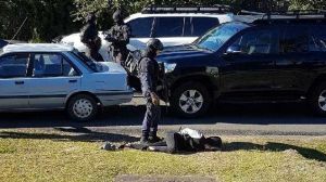 Heavily armed police put a woman in handcuffs in Wyee on Tuesday.