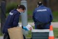 Police at the area where a man's body was found at Dunstan Reserve in West Brunswick.