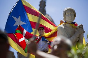 A man rises the hands during a protest organised by the National Assembly for Catalonia, to support the call for referendum in Barcelona, Spain, Sunday, June 11, 2017.