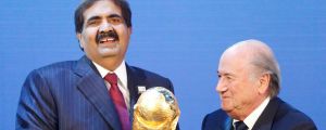 Bidding process: Sheikh Hamad bin Khalifa Al-Thani, emir of Qatar (left), is presented with the World Cup trophy by ...